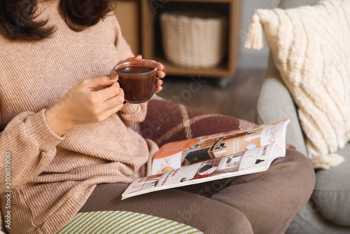 Woman relaxing at home with...