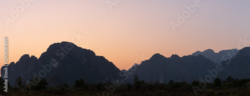 Beautiful natural panoramic countryside landscape with mountains at sunset. Nature background.