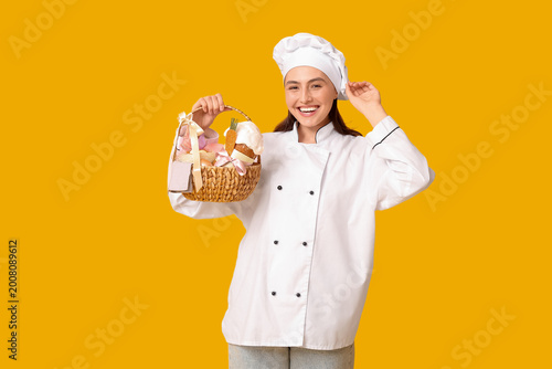 Happy female chef with East...