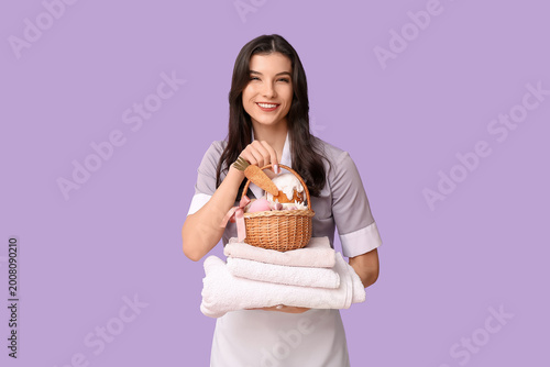Happy female chambermaid wi...