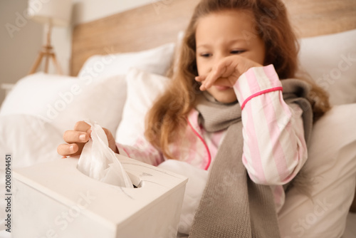 Sick little girl with tissu...