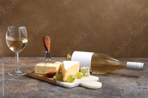 Board with tasty cheese, gr...
