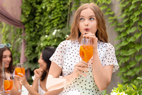 Beautiful young woman drink...