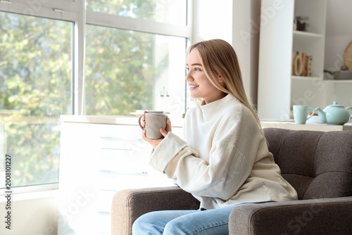 Young woman in cozy sweater...