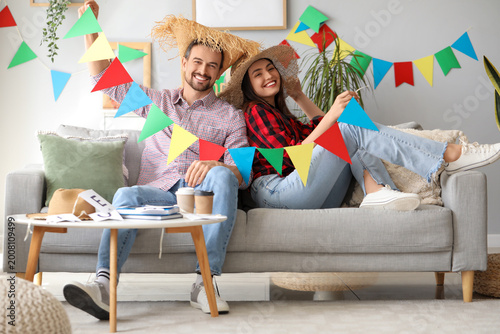 Young couple with flags cel...