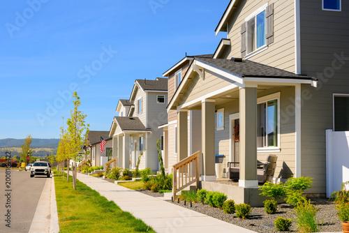 A modern residential street with townhome style homes in a planned community, with pedestrian friendly streets in an American suburb.