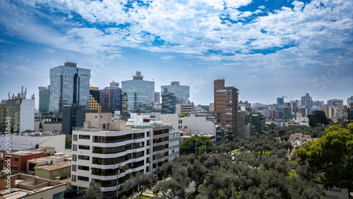 Obraz na plátně Wide aerial view of the urbanized and modern district of San Isidro, showcasing the mix of residential homes and high-rise buildings on a bright, sunny day in Lima, Peru