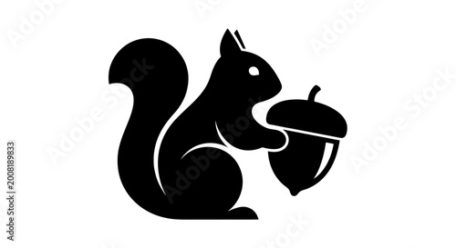 Black silhouette of a squirrel with acorn.