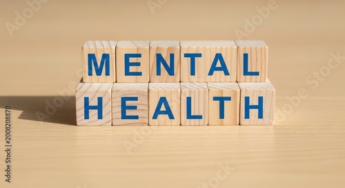Wooden blocks spelling mental health on textured background