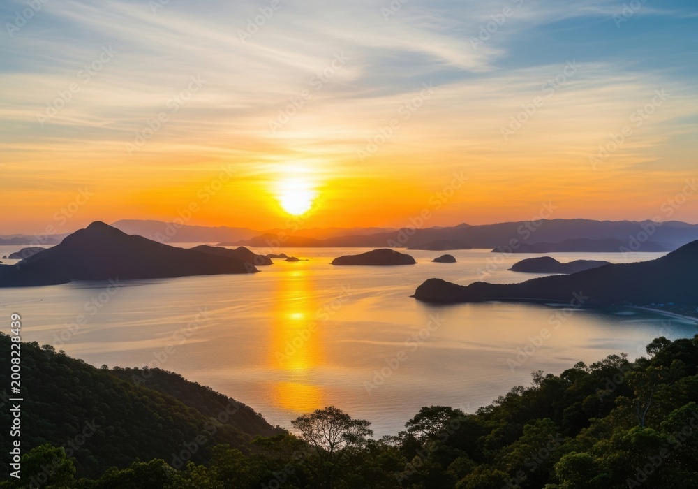 Fototapeta premium Dramatic sunrise over misty tropical islands with golden reflection