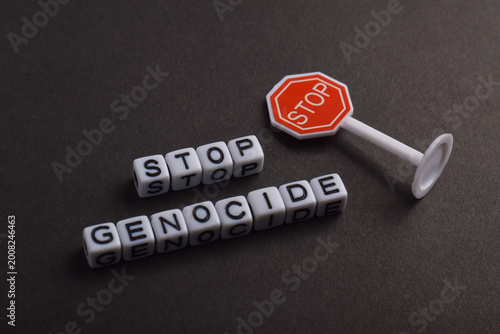 Valokuva Stop genocide message spelled with letter beads and a red stop sign, representing human rights, global awareness, and urgent call to end violence and mass atrocities