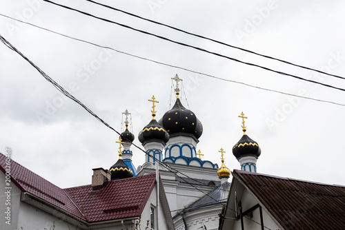 Valokuva Ancient Orthodox church architecture featuring luminous domes and peaceful surro