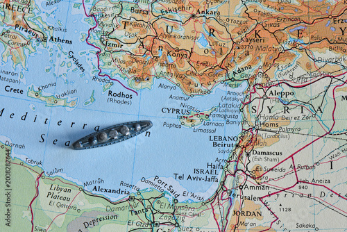 Quadro su tela Toy battleship on a vintage map of the Eastern Mediterranean Sea, near Cyprus, Turkey, and Lebanon, representing maritime travel, logistics, exploration, and naval strategy