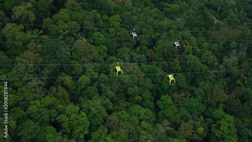 Cable car route crossing untouched forest in Ba Na Hills Vietnam with gondolas suspended above trees. Eco tourism concept shows sustainable travel, nature conservation and scenic aerial transport.