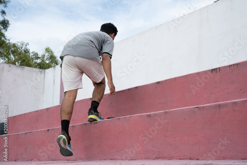 Bilde på lerret running up outdoor steps, Rear view of elderly man in sportswear running quickly