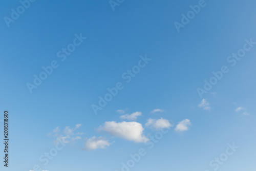 Photography Minimalist view of a few small white clouds in the lower third of a vast clear b