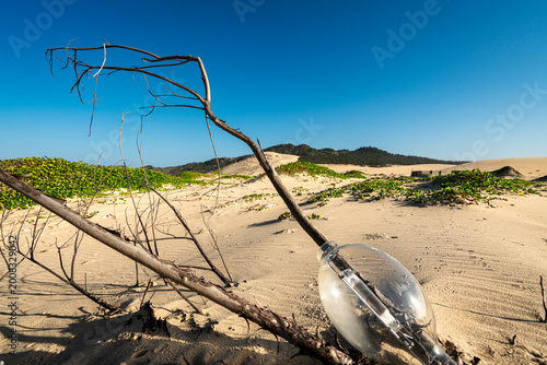 Photos Discarded metal halide street lamp globe on sand dunes Gia Lai Vietnam