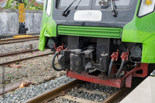 Close up of train coupler and connection system on railway track showing mechanical components and transportation infrastructure detail