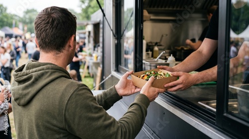 Man ordering healthy food from a street food truck vendor.