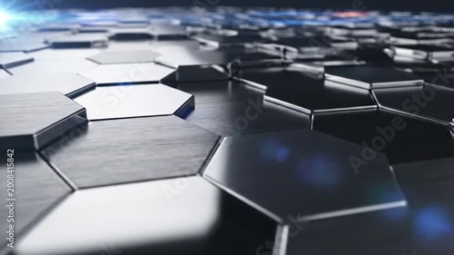 A close-up view of a metallic hexagonal pattern with a reflective surface, creating a modern and abstract design element