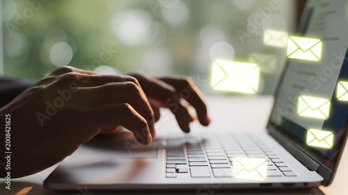 Hands typing on laptop with email icons highlighting artificial intelligence and digital evolution