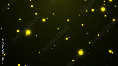 Abstract background with many small, glowing, yellow particles floating in the dark space, creating a magical effect