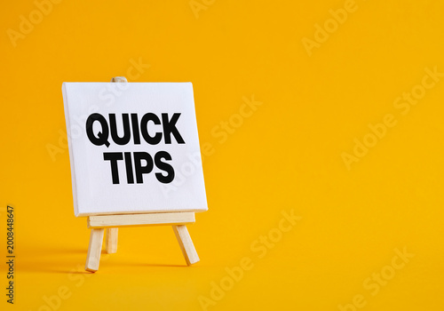 White Canvas Showing Quick Tips announcement on Wooden Easel with Yellow Background
