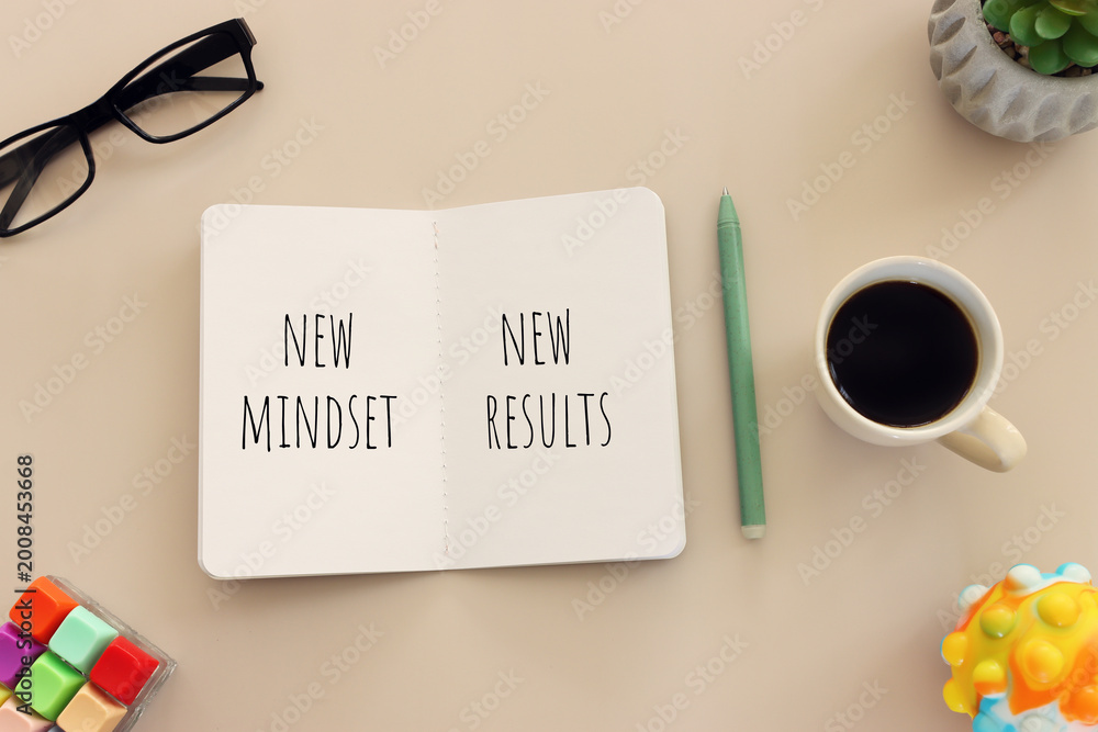 Naklejka premium image of notebook with the text new mindset. success and personal development concept