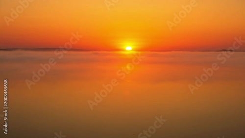 Sunset over calm sea water.