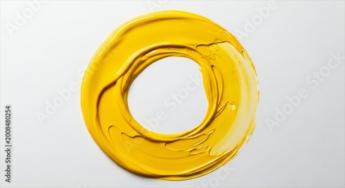 Yellow paint smear in a circular shape on a light gray background