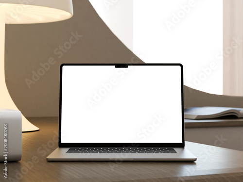 Laptop mockup on desk with lamp and book in a cozy workspace setting.