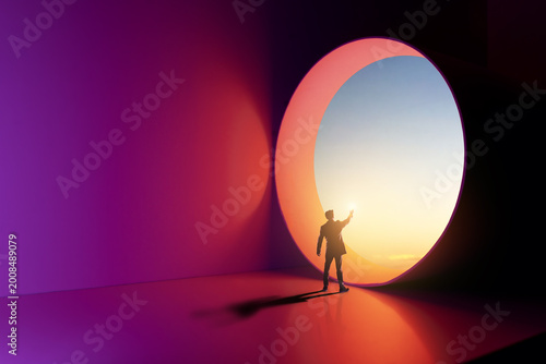 Photos Silhouette of Man Reaching Toward Bright Portal in Abstract Colorful Room Concep