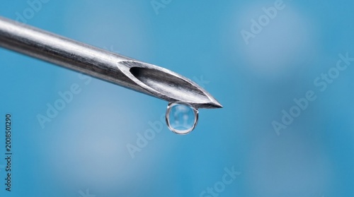 Hypodermic needle tip with vaccine droplet hanging