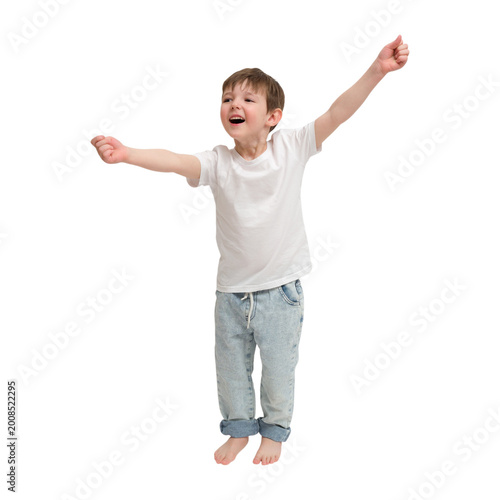 Child boy jumping with happiness on transparent background. Excited kid in white t-shirt and jeans expressing joy and success. Energetic young male celebrating achievement. A kid aged 4 years