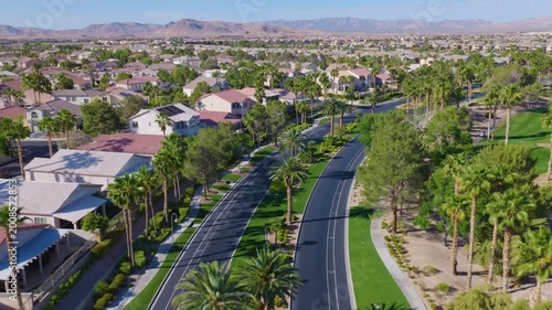 Southwest Las Vegas Aerial Pullback View of Palm Lined Road by Golf Course Homes
