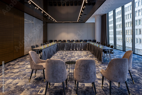 Large conference hall interior with rows of chairs for presentations