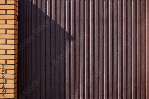 A brown metal fence around the house