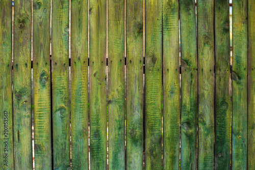 Old wooden green fence, background