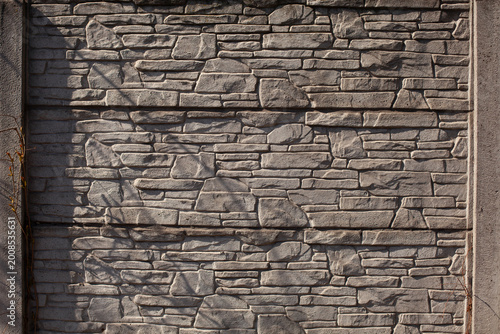 Gray stone fence around the house