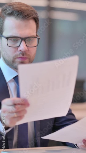 Businessman Reading Documents in Office