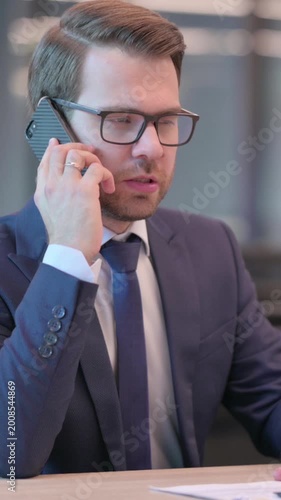 Businessman Talking on Phone in Office