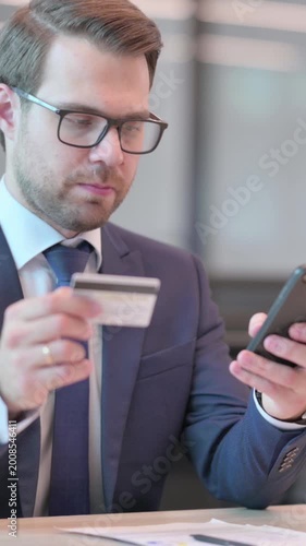 Businessman Reacting to Loss on Smartphone in Office