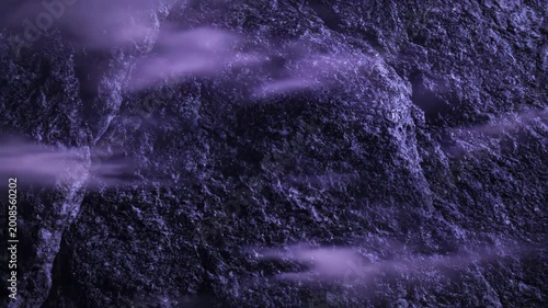 Close-up texture of dark purple rough stone surface displaying granular details and deep shadows with a dramatic and mysterious atmosphere