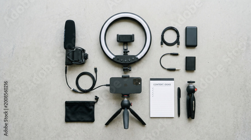 flat lay photography equipment setup with ring light and accessories on neutral background