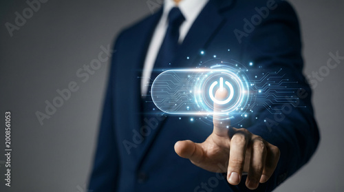 Businessman pressing virtual power button, symbolizing digital startup, activation, and modern business control.