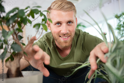 young man taking care of the aromatic plants