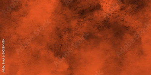 Fotografija Eerie black background with billowing orange smoke on black background