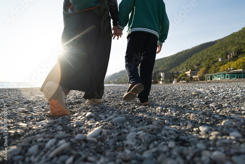 walk on pebble beach in sunny