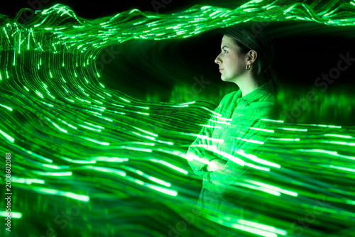 Specialist surrounded by glowing green data waves in cyberspace