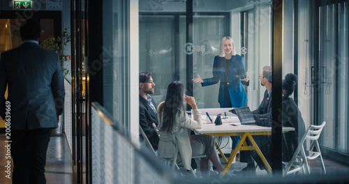 Quadro su tela Businesswoman Leads a Strategic Planning Meeting in a Glass Conference Room, Exp